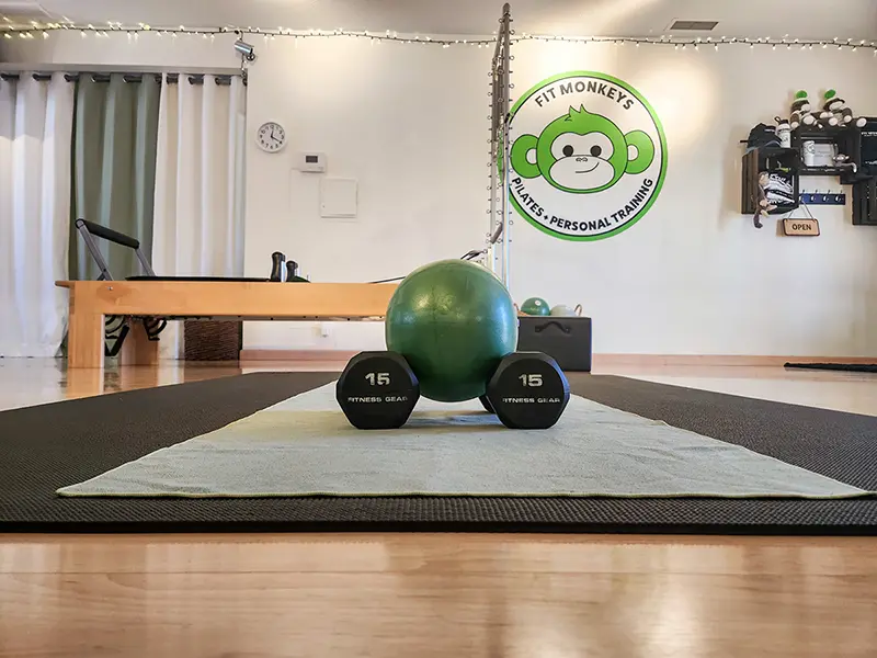 Dumbbells and Pilates reformer inside the Fit Monkeys personal training studio in Carlsbad, California.